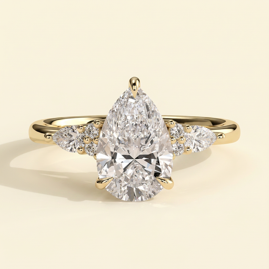 The Ilona - Pear Cut Lab Grown Diamond Three Claw Tulip Gallery Solitaire with Pear and Round Shoulder Stones Engagement Ring - Yellow Gold
