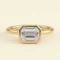 The Zaia - Emerald Cut Lab Grown Diamond East West Bezel Set Solitaire with Open Cathedral Setting Engagement Ring