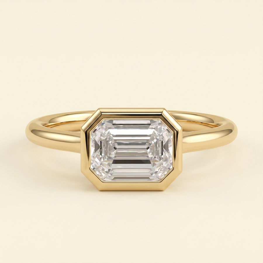 The Zaia - Emerald Cut Lab Grown Diamond East West Bezel Set Solitaire with Open Cathedral Setting Engagement Ring - Yellow Gold
