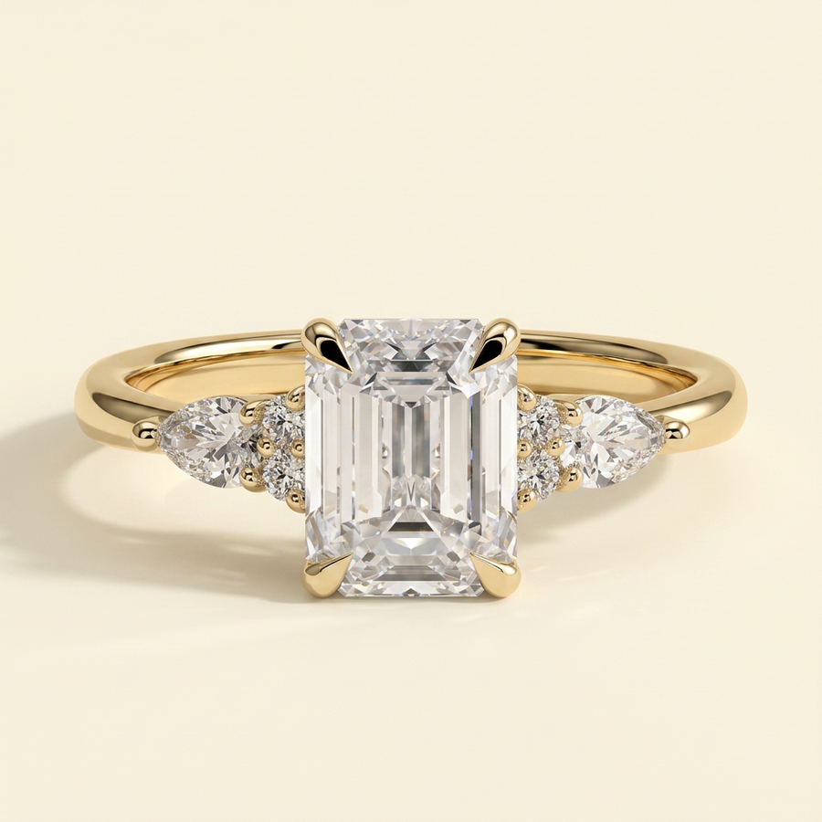 The Belisse - Emerald Cut Lab Grown Diamond Four Claw Solitaire with East West Pear and Round Shoulder Accents Engagement Ring - Yellow Gold
