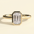 The Helia - Emerald Cut Lab Grown Diamond Bezel Set Solitaire with Open Cathedral Engagement Ring