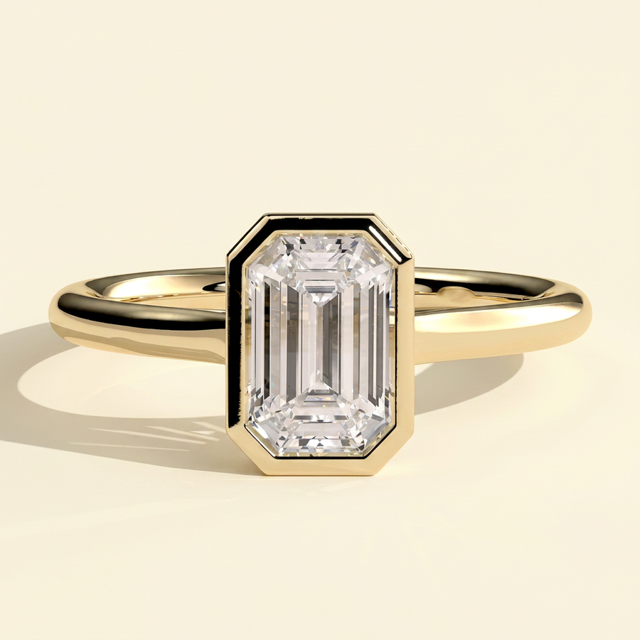 The Helia - Emerald Cut Lab Grown Diamond Bezel Set Solitaire with Open Cathedral Engagement Ring - Yellow Gold