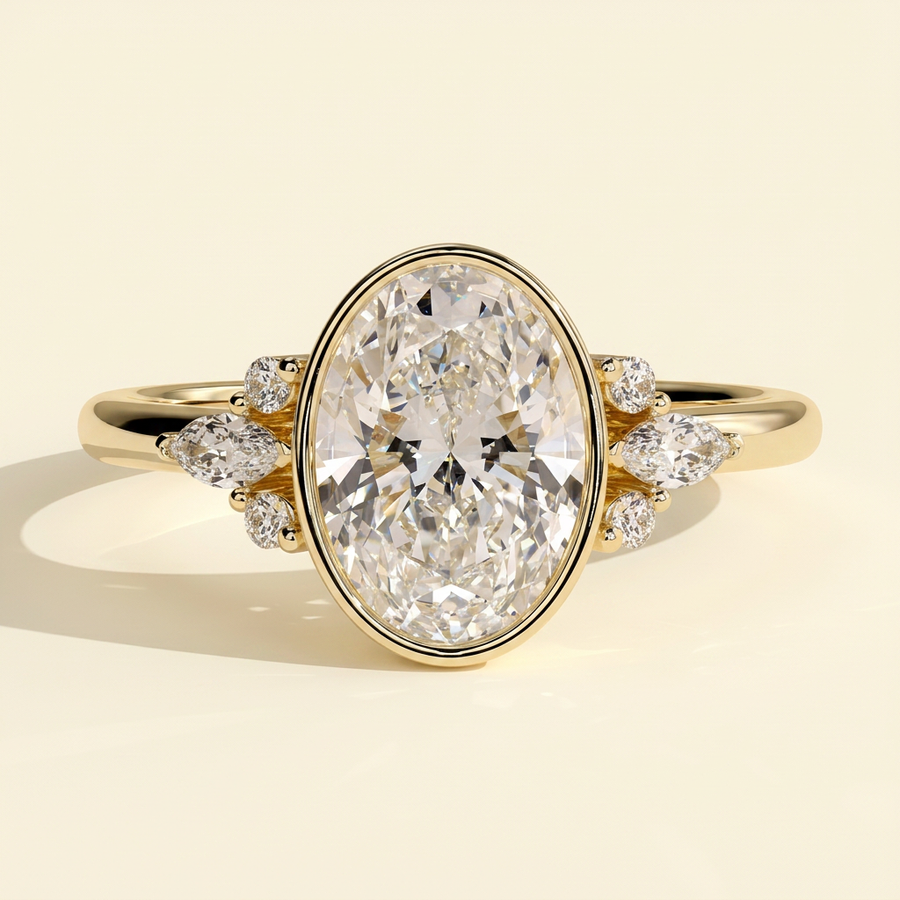 The Ziva - Oval Cut Lab Grown Diamond Bezel Set Solitaire with Marquise and Round Shoulder Stones Engagement Ring - Yellow Gold