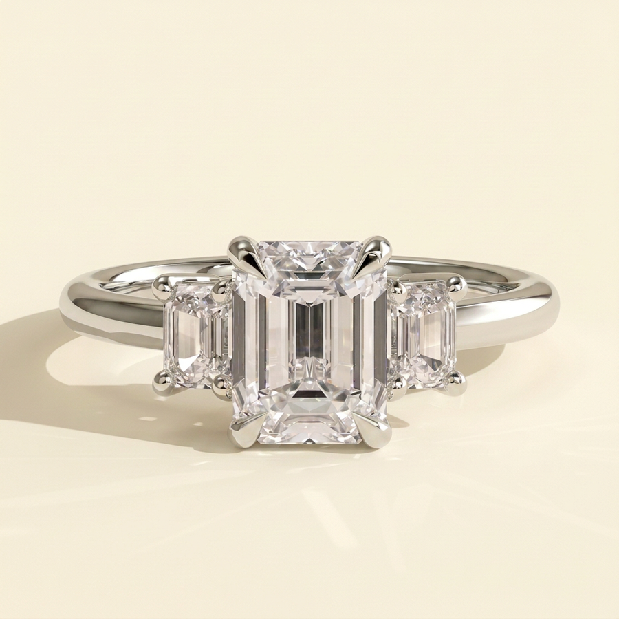 The Miriana - Emerald Cut Lab Grown Diamond Three Stone Engagement Ring with Matching Emerald Side Stones and Low Basket Setting - White Gold