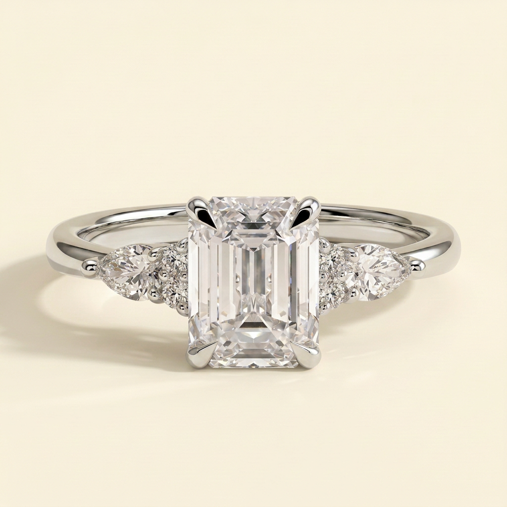 The Belisse - Emerald Cut Lab Grown Diamond Four Claw Solitaire with East West Pear and Round Shoulder Accents Engagement Ring
